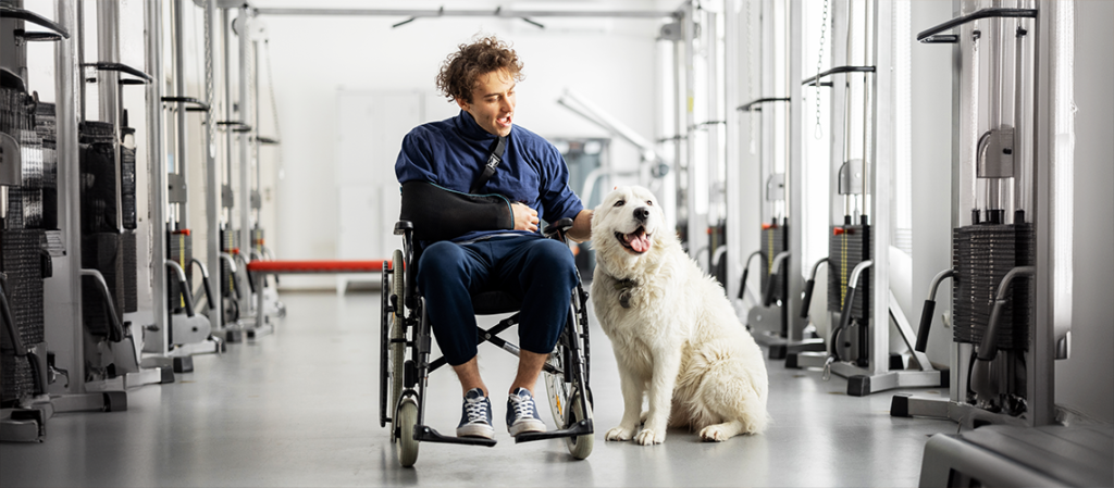 A man in a wheelchair with a dog